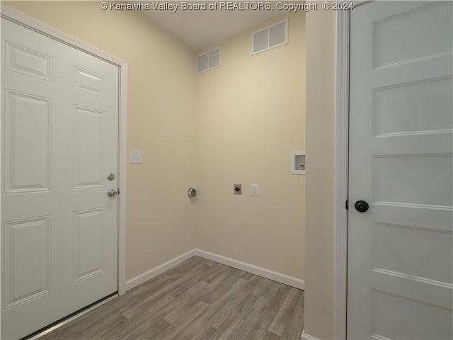 laundry area featuring hookup for an electric dryer, hookup for a washing machine, and light hardwood / wood-style flooring