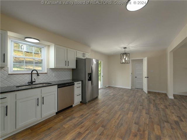 kitchen featuring decorative backsplash, sink, white cabinets, and appliances with stainless steel finishes