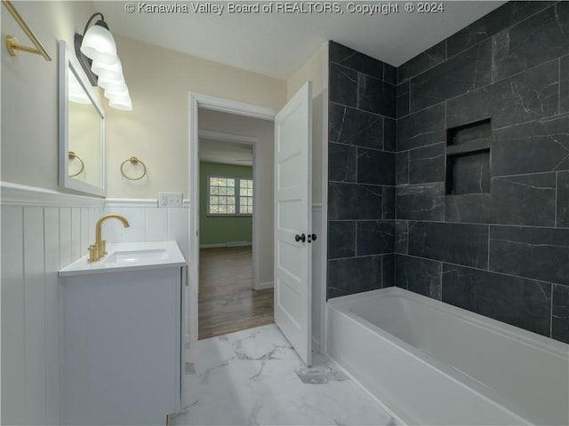 bathroom featuring vanity and tiled shower / bath