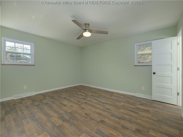 unfurnished room with dark wood-type flooring and ceiling fan