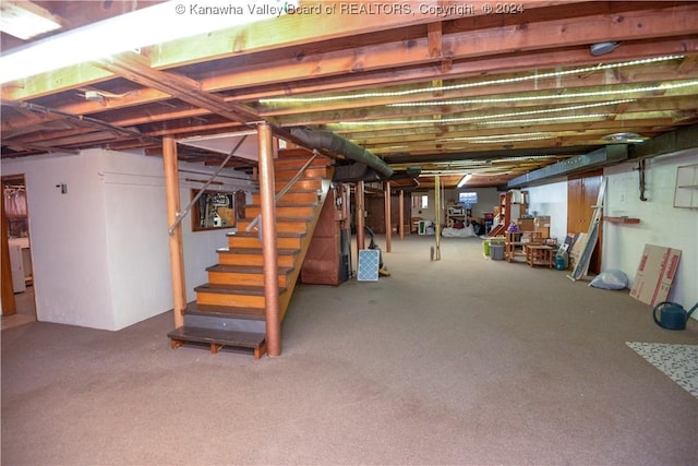 basement featuring washer / dryer and carpet floors