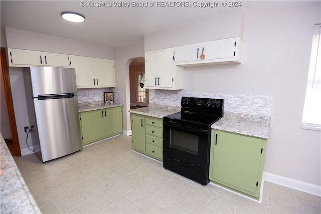 kitchen featuring stainless steel fridge, tasteful backsplash, black range with electric cooktop, white cabinets, and green cabinets