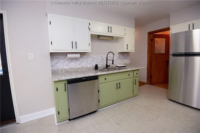 kitchen with backsplash, stainless steel appliances, sink, green cabinetry, and white cabinetry