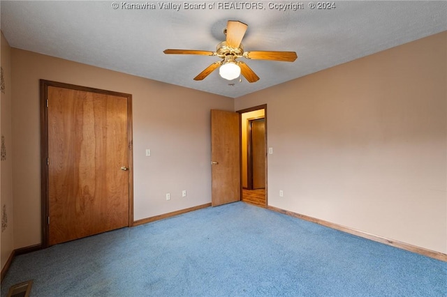 unfurnished room with ceiling fan and light colored carpet