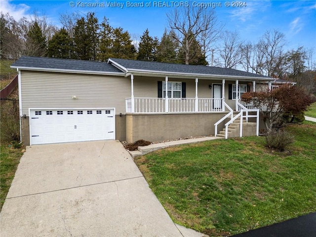 ranch-style house with covered porch, a garage, and a front lawn