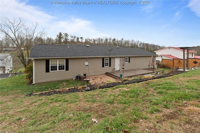 rear view of house with a yard and a patio area