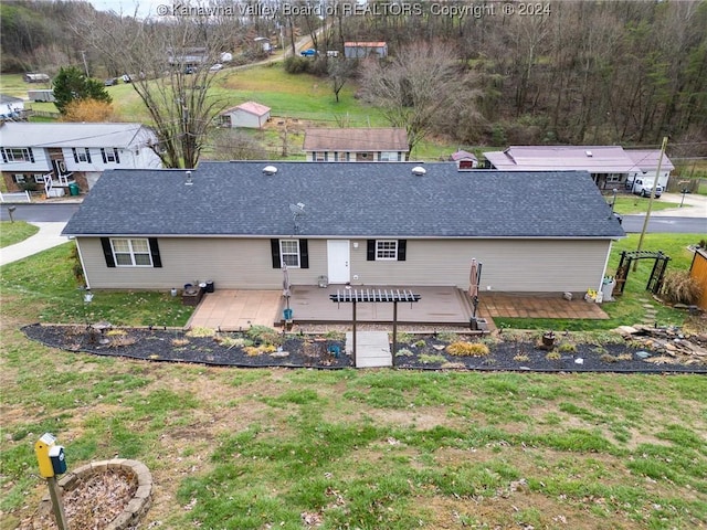 rear view of property featuring a lawn and a wooden deck