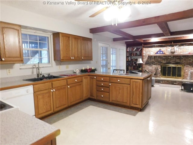 kitchen with kitchen peninsula, a brick fireplace, sink, dishwasher, and beamed ceiling