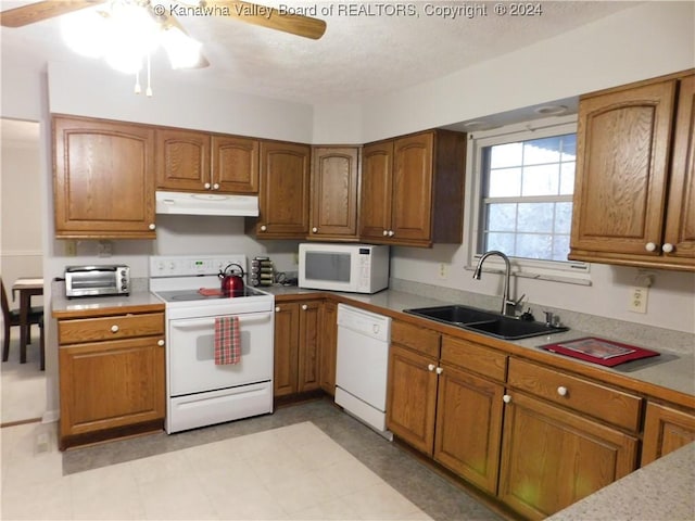 kitchen featuring a textured ceiling, ceiling fan, white appliances, and sink