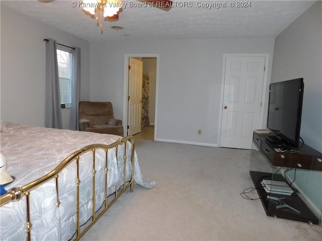 bedroom featuring ensuite bath, ceiling fan, and carpet