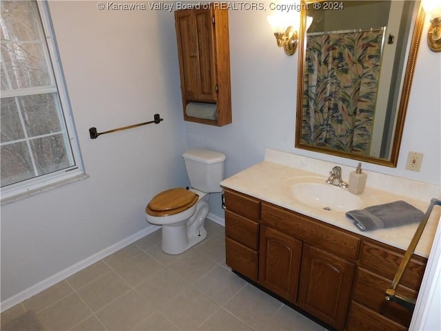 bathroom featuring tile patterned floors, vanity, and toilet