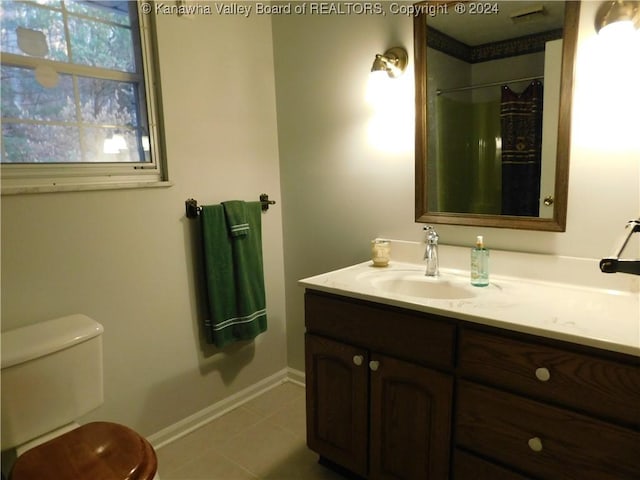 bathroom with tile patterned floors, vanity, curtained shower, and toilet