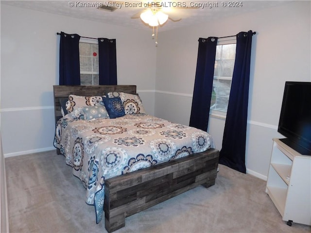 bedroom with ceiling fan and light colored carpet