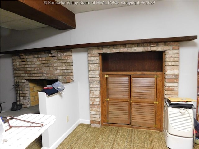 room details with beam ceiling, a fireplace, and carpet