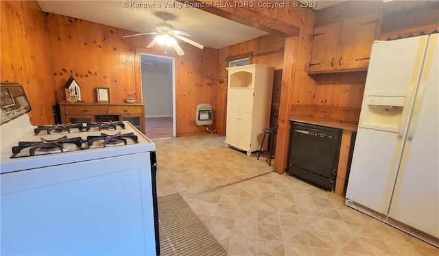 kitchen featuring heating unit, ceiling fan, wooden walls, and white appliances