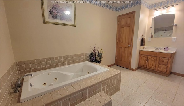 bathroom with tile patterned floors, a relaxing tiled tub, and vanity