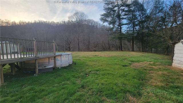 view of yard with a pool side deck