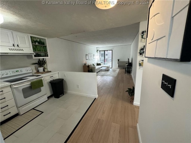 kitchen with a textured ceiling, white cabinetry, white range with electric cooktop, and light hardwood / wood-style floors