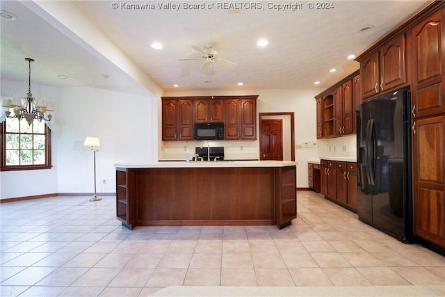 kitchen featuring ceiling fan with notable chandelier, sink, black appliances, a center island with sink, and hanging light fixtures