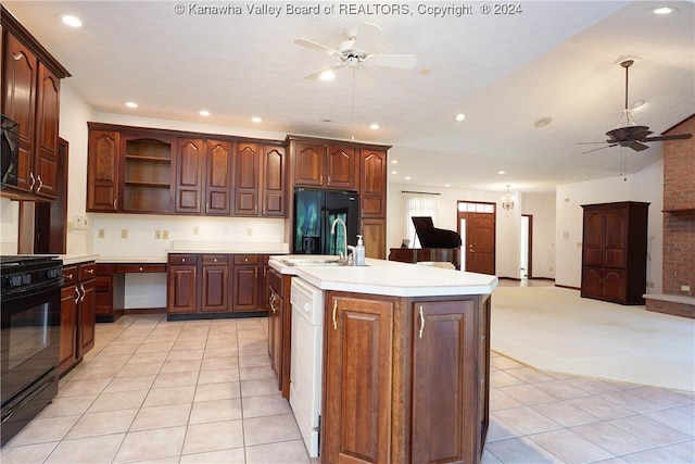 kitchen featuring a kitchen island with sink, black appliances, sink, ceiling fan, and light colored carpet