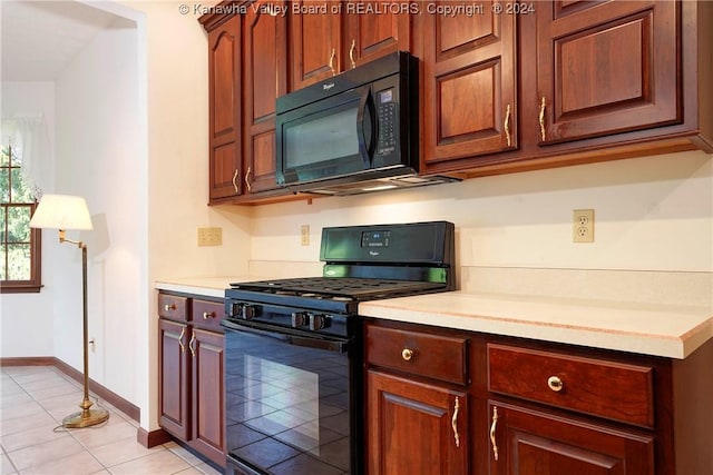 kitchen featuring black appliances and light tile patterned flooring