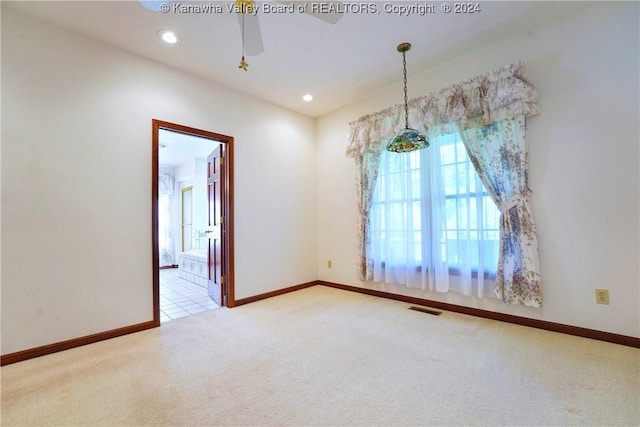 carpeted empty room with ceiling fan