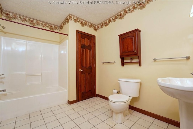 bathroom with toilet, tile patterned flooring, a textured ceiling, and tub / shower combination