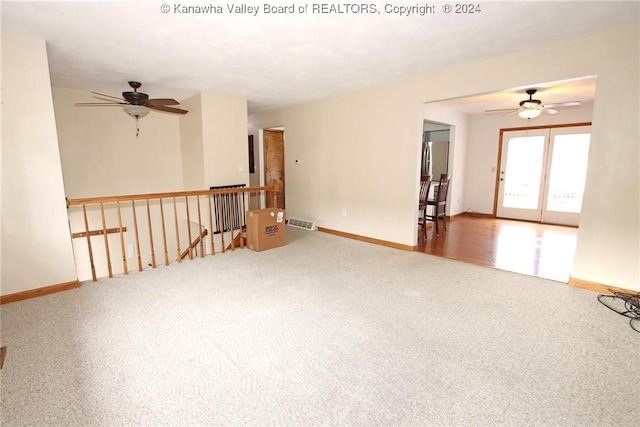 carpeted spare room featuring ceiling fan