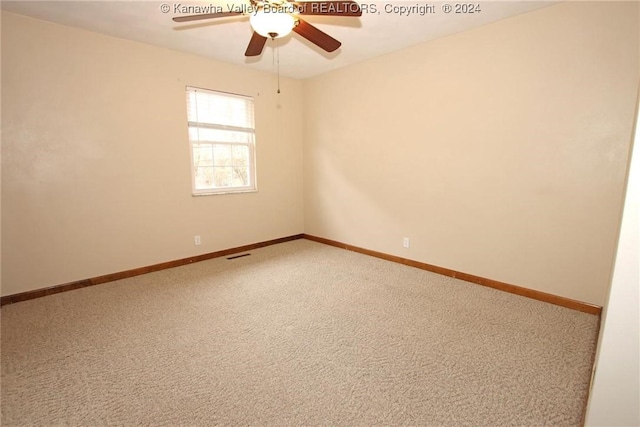 spare room featuring carpet flooring and ceiling fan