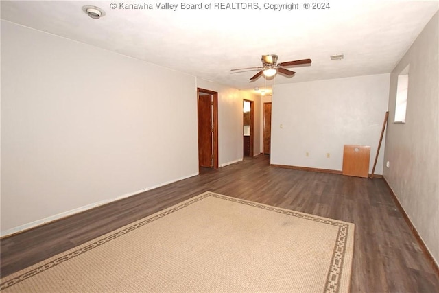 spare room with ceiling fan and dark wood-type flooring