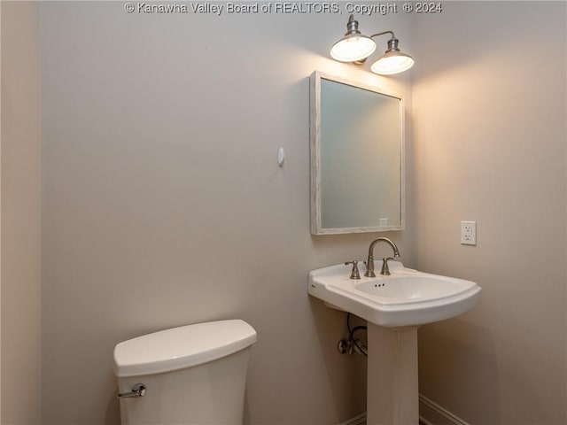 bathroom with toilet and sink