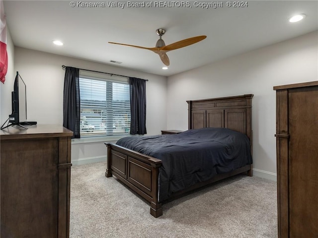 bedroom featuring ceiling fan and light carpet