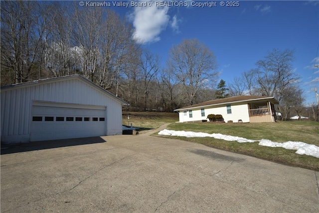 exterior space featuring a garage, a yard, and an outbuilding