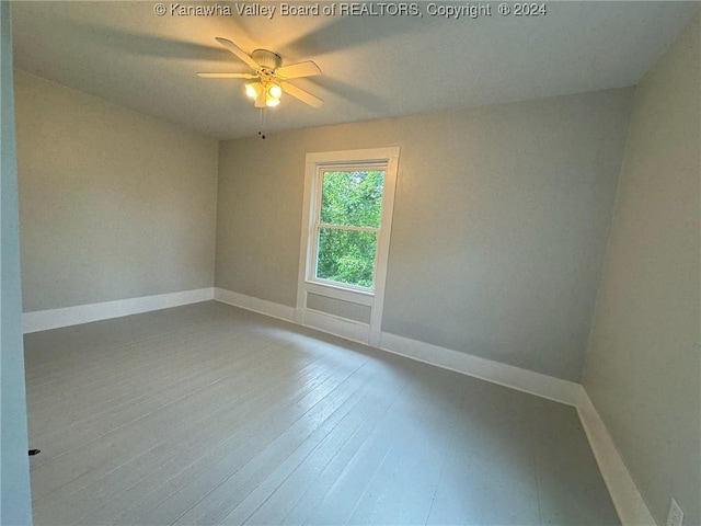 empty room featuring ceiling fan and hardwood / wood-style floors