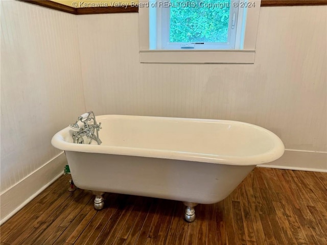 bathroom featuring hardwood / wood-style flooring and a washtub