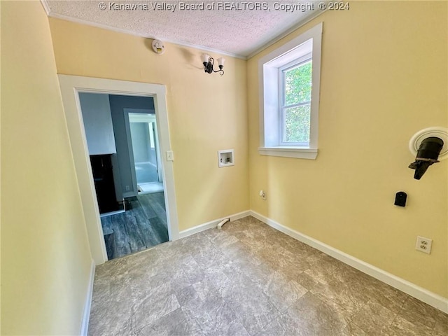 laundry area with washer hookup, a textured ceiling, and an inviting chandelier