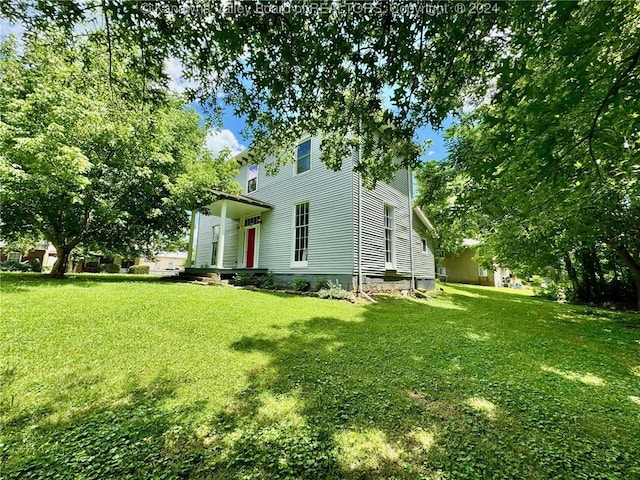 view of side of home featuring a yard