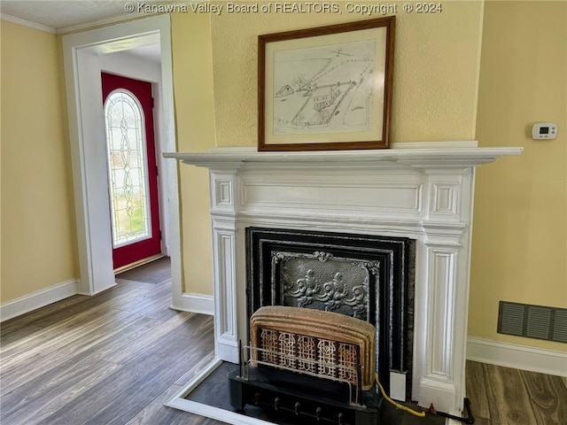 room details with hardwood / wood-style flooring and ornamental molding