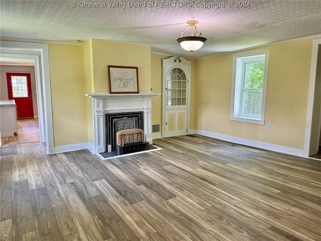 unfurnished living room featuring a textured ceiling and hardwood / wood-style flooring