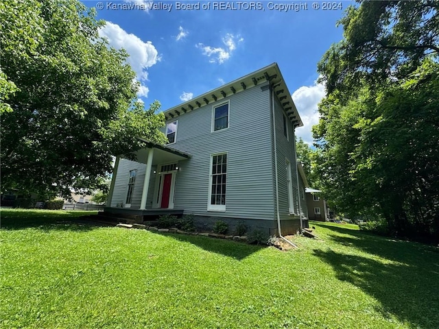 rear view of house with a yard