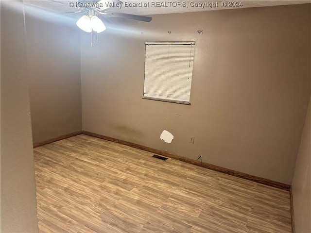 spare room featuring ceiling fan and light wood-type flooring