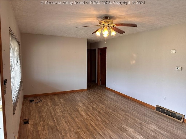 spare room with wood-type flooring, a textured ceiling, and ceiling fan