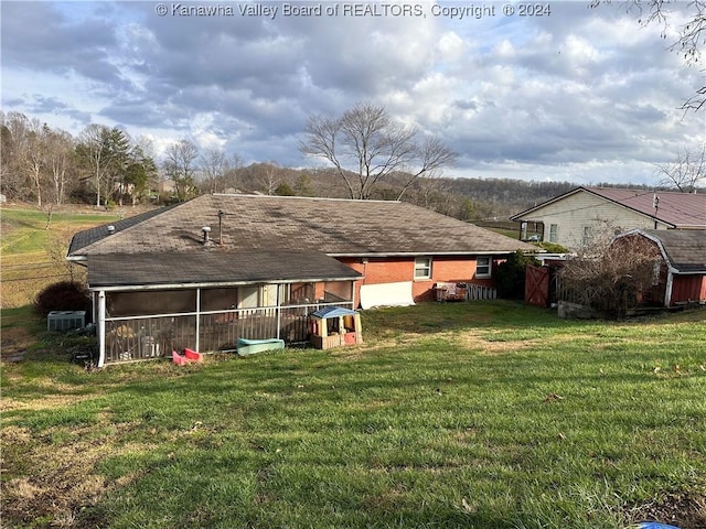 back of property with a lawn