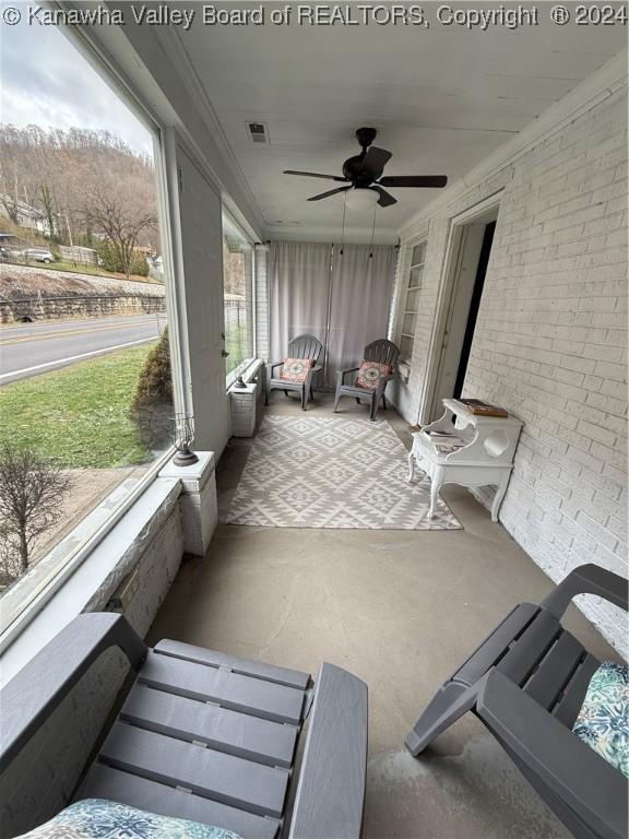 sunroom / solarium featuring a wealth of natural light and ceiling fan