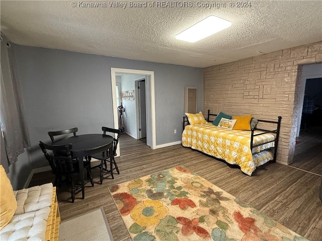 bedroom featuring dark hardwood / wood-style floors and a textured ceiling