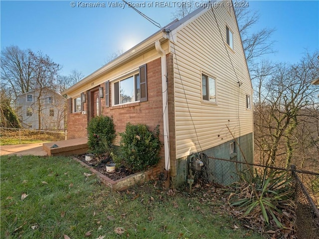 view of side of home with a lawn