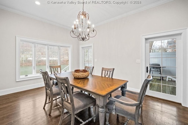 dining area with crown molding, dark hardwood / wood-style floors, and an inviting chandelier