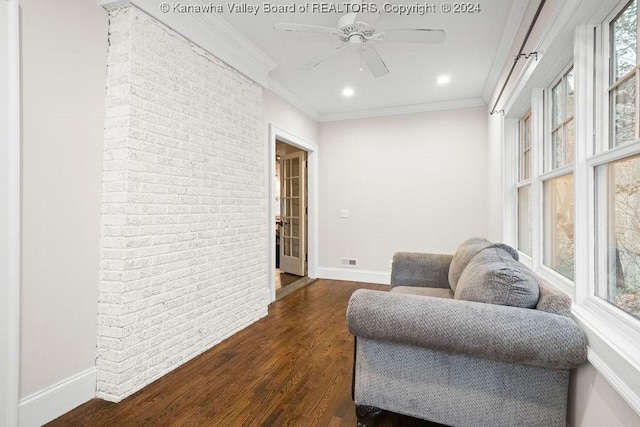 sitting room featuring ceiling fan, dark hardwood / wood-style flooring, and ornamental molding