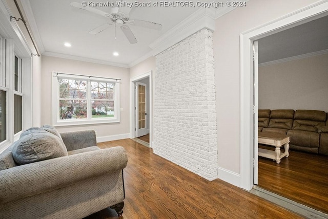 sitting room featuring hardwood / wood-style floors, ceiling fan, and ornamental molding