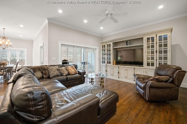 living room with dark hardwood / wood-style flooring, ornamental molding, and a wealth of natural light